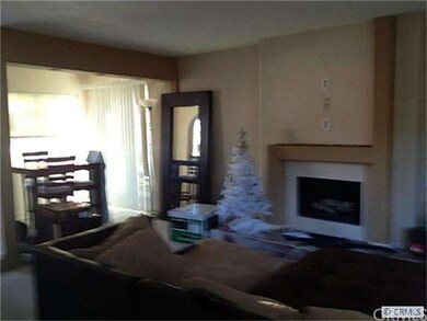 Living room with fireplace adjacent to Dining room