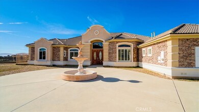 Front of house and fountain.