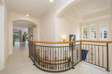 Corridor featuring crown molding, arched walkways, recessed lighting, and light tile patterned flooring