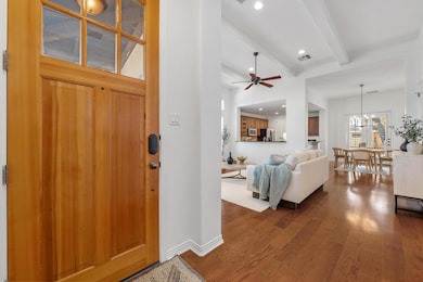 Foyer with beamed ceiling, dark wood-type floorin