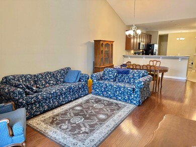 Living room featuring dark wood-type flooring, hig