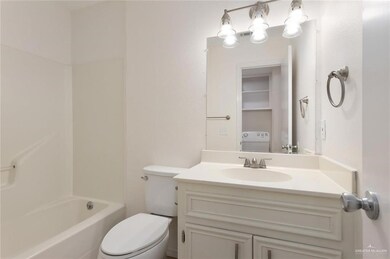 Bathroom with toilet, washer / clothes dryer, and vanity