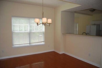 Formal dining room with hardwood flooring.  Also a breakfast bar area open to kitchen