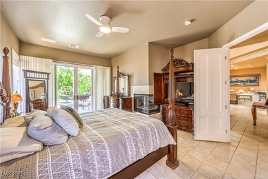 Bedroom with access to exterior, light tile patter