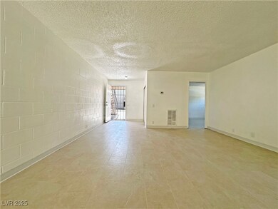 Spare room with a textured ceiling, concrete block