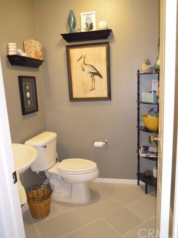 Guest bathroom with tile floor and upgraded sink.