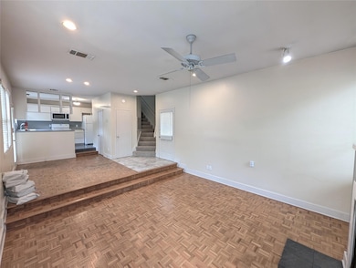 Unfurnished living room featuring baseboards, cei