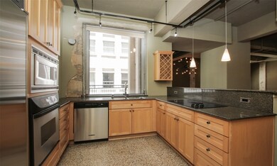 Designer kitchen features Terrazzo floors, wood ca