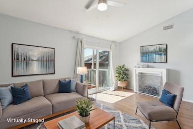 Living room featuring visible vents, wood finishe