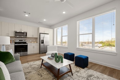 Living room with light wood-style floors, baseboa