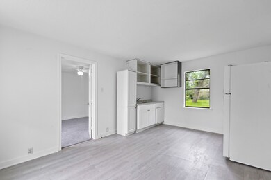Bright, minimalist kitchen with white cabinets, a