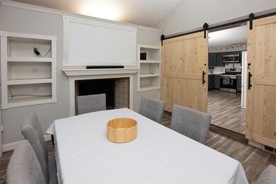 Dining room with built in bookcases and fireplace.