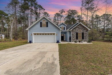 Traditional home featuring stone siding, concrete 