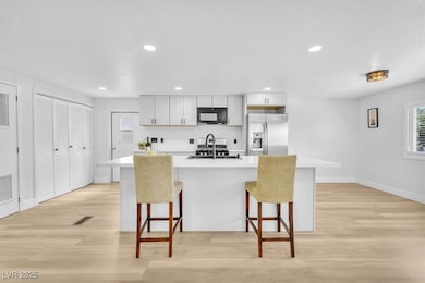Kitchen featuring black microwave, stainless steel