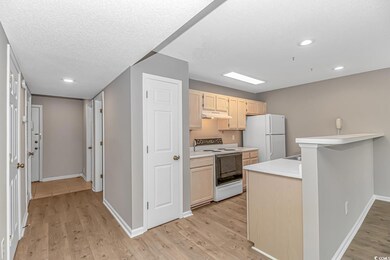 Kitchen with kitchen peninsula, light brown cabine