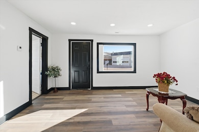 Foyer with recessed lighting and wood finished floors