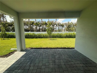 Covered lanai with landscaped backyard view
