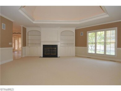 Den/Family/Great Room. A deep domed ceiling with indirect lighting, built-ins that flank the gas-log fireplace, and a neutral decor make for a relaxing gathering place
