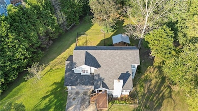 View from above of property featuring a tree filled landscape