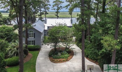 Circular driveway leads to front porch and two car