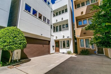 A striking modern façade introduces the home, with crisp architectural lines and numerous windows that hint at bright interiors.