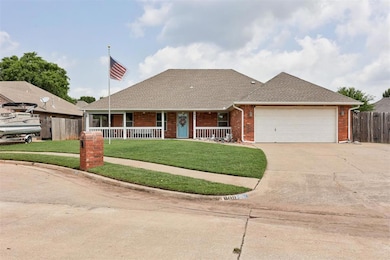 View of front of house with concrete driveway, a garage, covered porch, brick siding, and roof with shingles