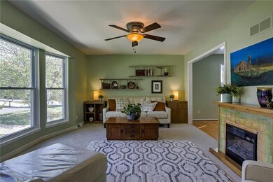 Formal living room has ceiling fan, new paint, and