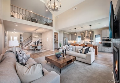 Living room with a high ceiling, sink, an inviting
