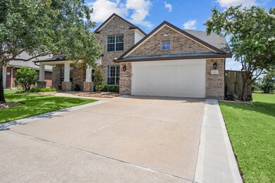 Widened driveway leading to oversized 3-car tandem garage.