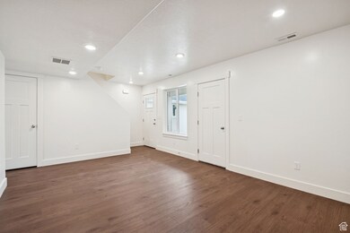 Foyer entrance featuring dark wood-style flooring and recessed lighting