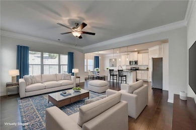 Living room featuring baseboards, dark wood-style 