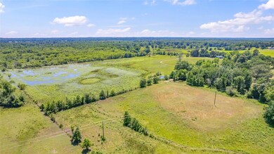 Aerial view featuring a rural view and a water vie