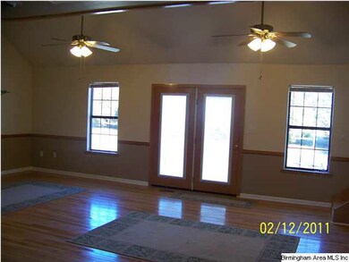 Great room has cathedral ceilings, hardwood floors