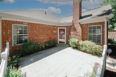 Entrance to property with brick siding, and a patio area