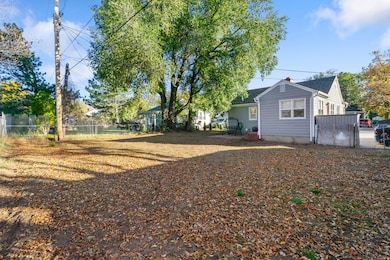 Fenced backyard featuring a gate