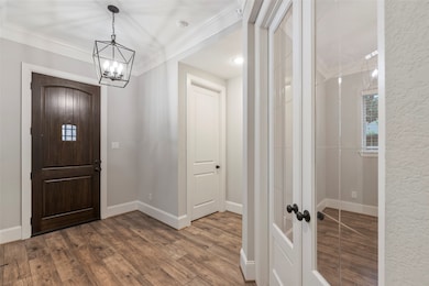 Entry features wood door with security window, mod