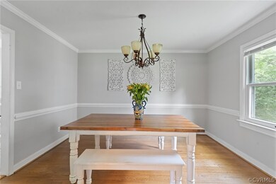 Dining room with ornamental molding, a notable cha