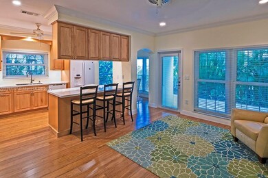 family room looks onto kitchen and back patio/gard