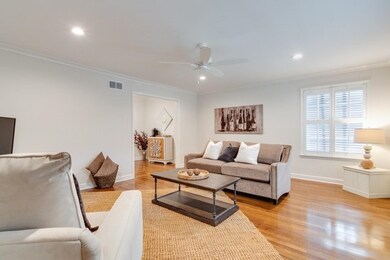 Living area with crown molding, recessed lighting,
