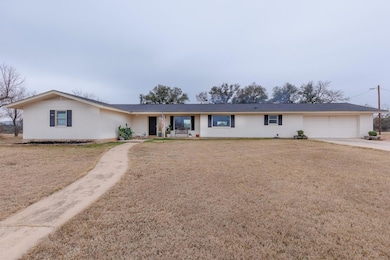 Single story home featuring brick siding, concret