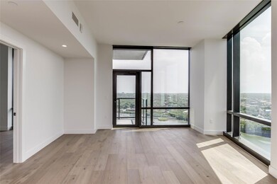 Spare room featuring wood finished floors, basebo