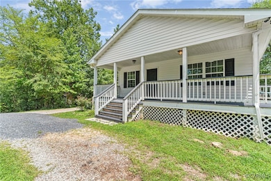 Bungalow with covered porch and gravel driveway