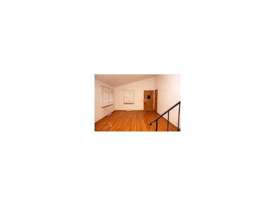 Nice hardwood floors in living room.  Door to righ