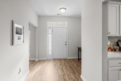 Entryway featuring baseboards and light wood-style flooring