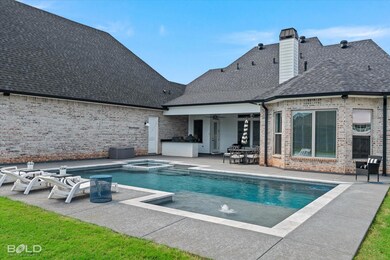 View of swimming pool with an in ground hot tub an