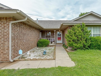 Property entrance featuring covered porch, brick s