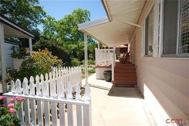 Charming picket fencing accents the front patio an