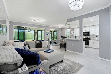 Living area with crown molding and a chandelier
