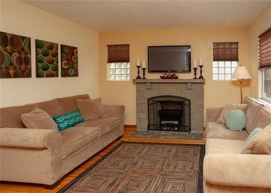 The decorative fireplace and custom blinds add cha