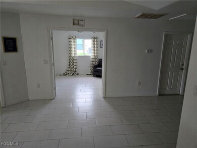 Unfurnished room featuring baseboards and light tile patterned floors